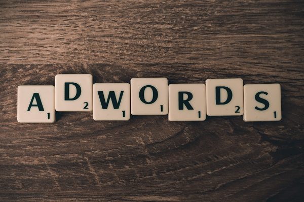 Scrabble tiles spelling "AdWords" on a table