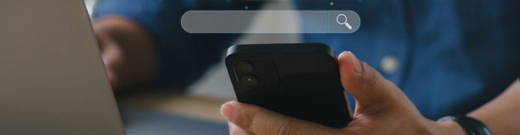 Man holding phone with search bar and icons on top of it.