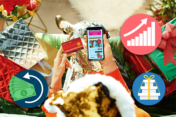 Person holding phone and debit card surrounded by holiday decor.