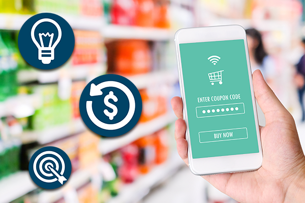 Mobile phone showing a screen to enter a coupon code while owner stands in a store.