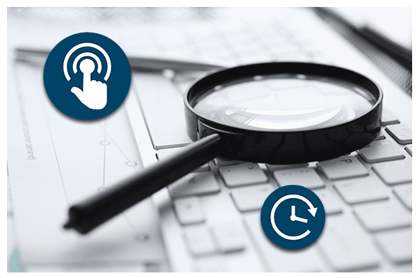 Magnifying glass on a laptop keyboard.