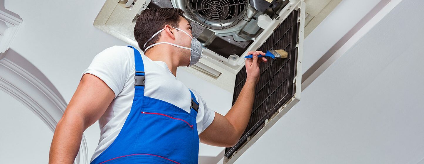 Person cleaning air filter.