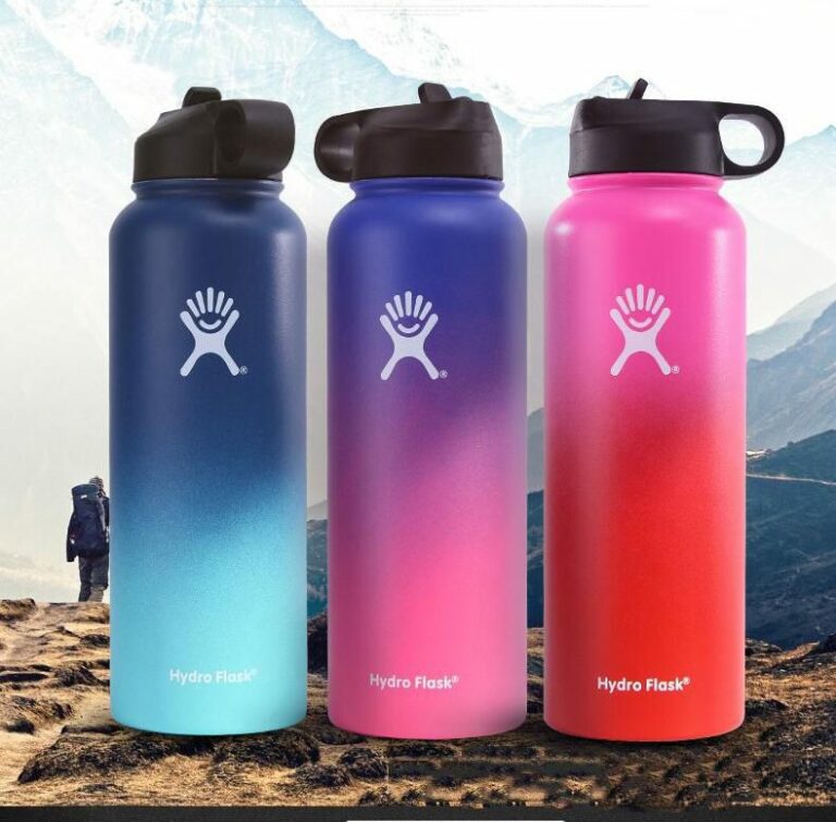 3 colorful Hydro Flask bottles on a mountainside.
