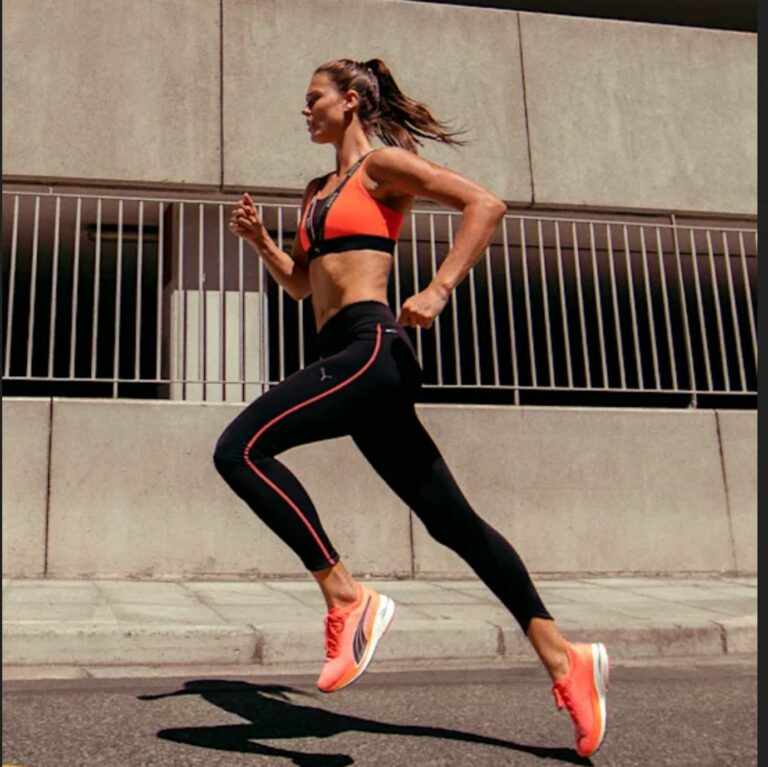 Woman running in orange sneakers.