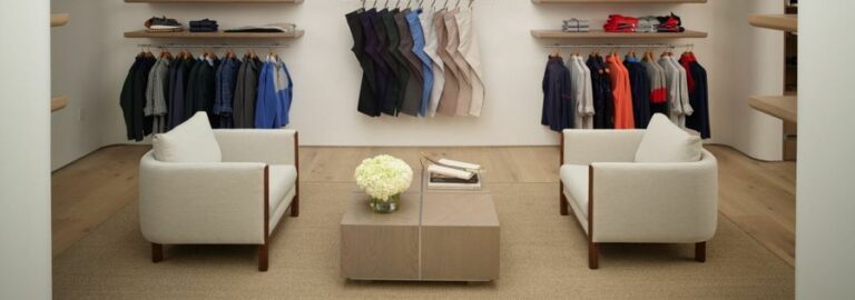 Well-organized, luxury fashion showroom stocked with up-scale clothing for men.
