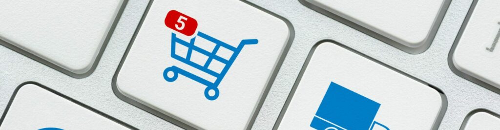 Online shopping / ecommerce and retail sale concept : Shopping cart, delivery van, credit card, world globe logo on a laptop keyboard, depicts customers order things from retailer sites using internet