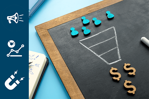 A chalkboard with a marketing funnel drawn on it and a notebook with notes about making a profit beside it.