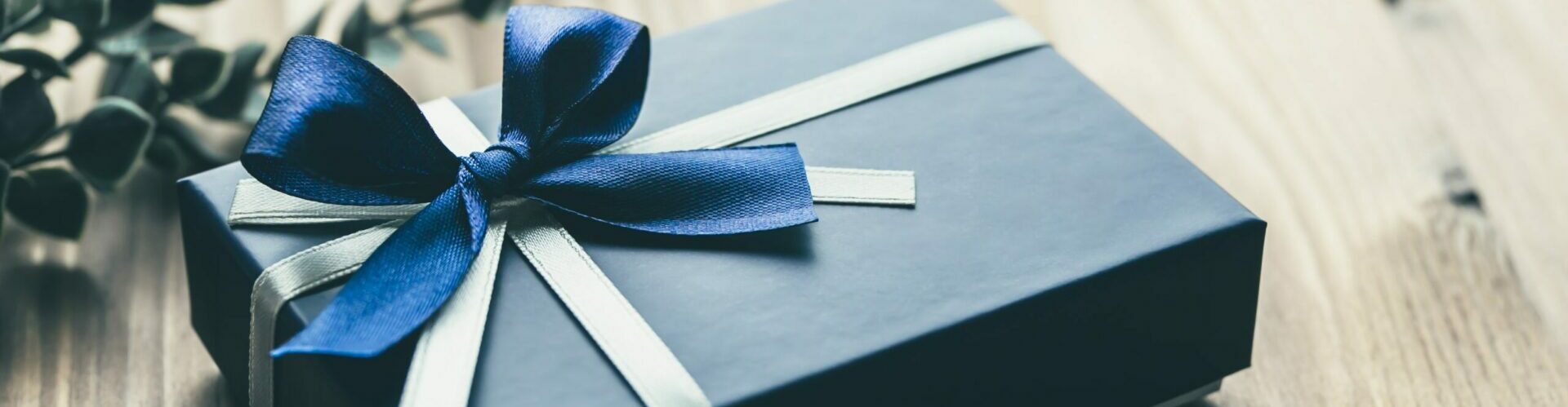 Holiday Ecommerce Strategies for 2022 - blue gift box with blue ribbon on floor