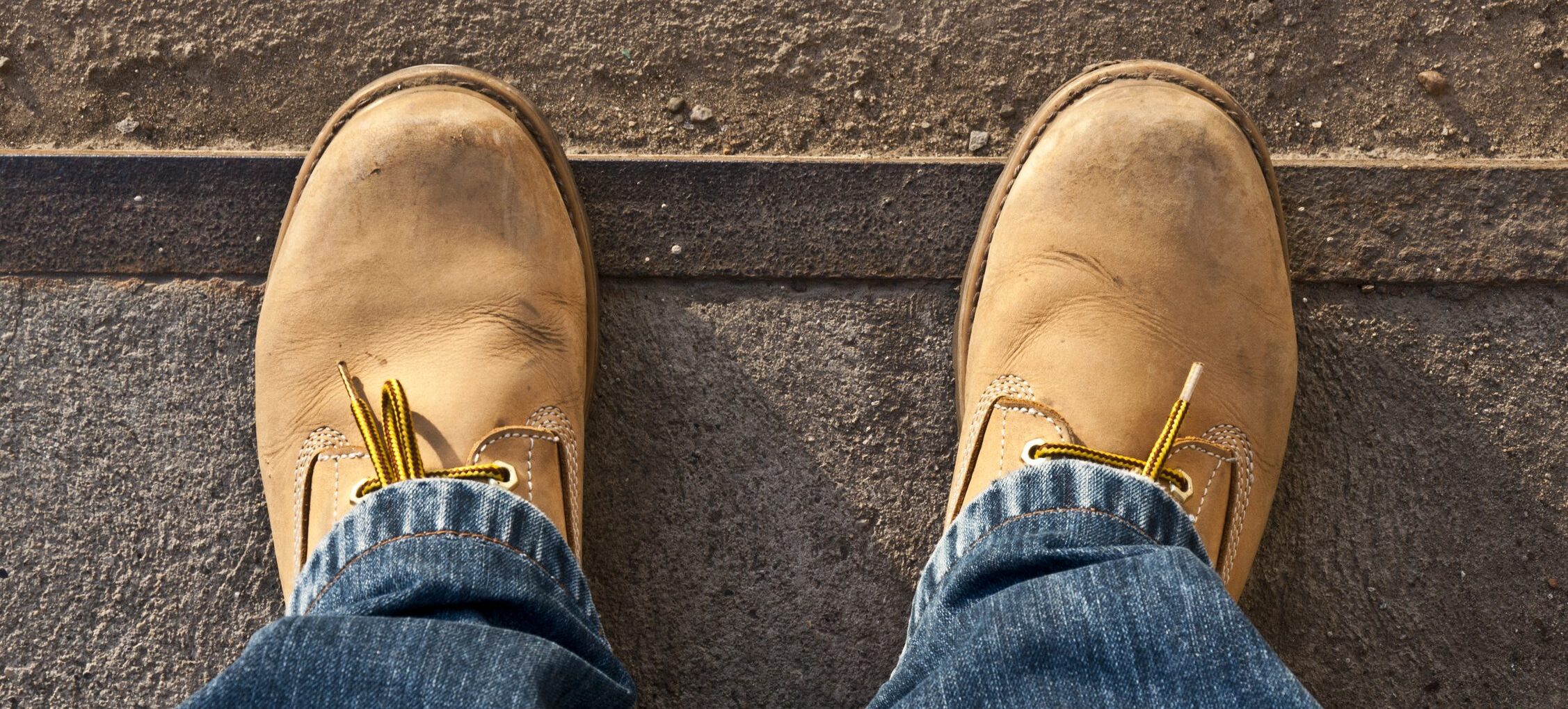 Yellow work boots from the bird's eye perspective.