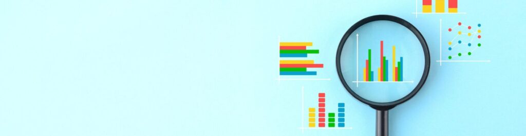 Magnifying glass and various business graphs on light blue background.