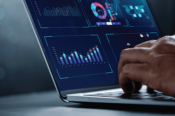 Analyst working with computer in Business Analytics and Data Management System to make report with KPI and metrics connected to database. Corporate strategy for finance, operations, sales, marketing.