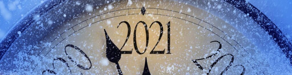 Compass pointing to 2021 with snow falling around it.