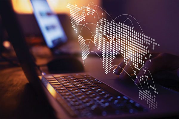 Map of world floating above laptop.