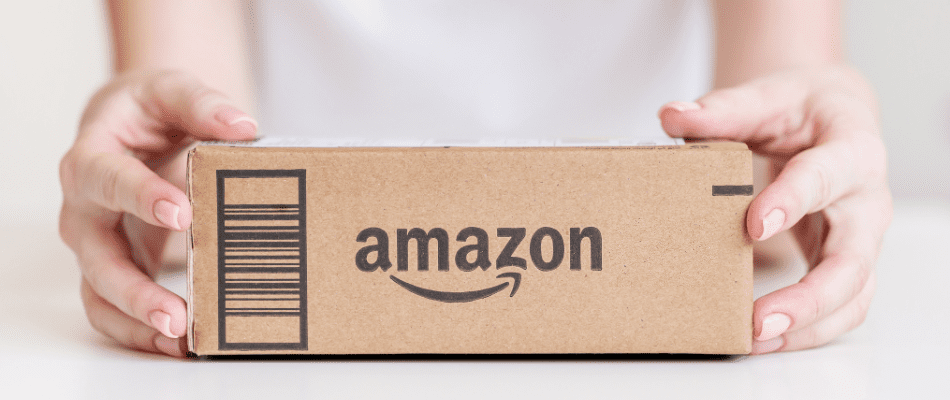 Hands holding amazon delivery box