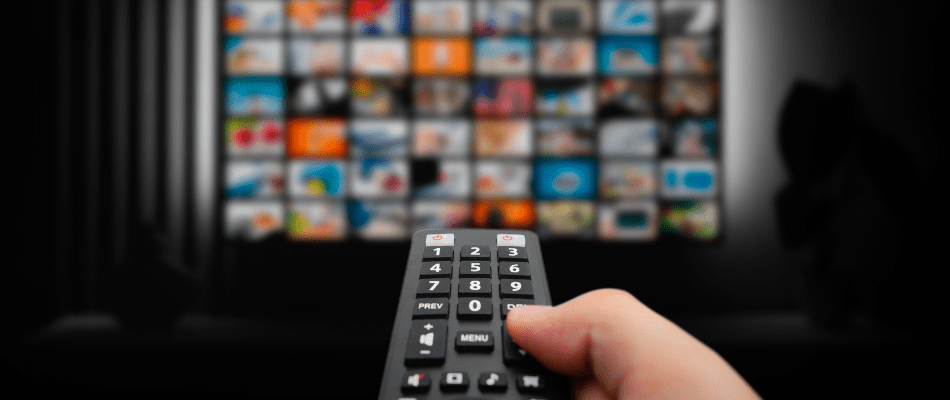 hand holding remote pointed towards tv featuring ctv channels