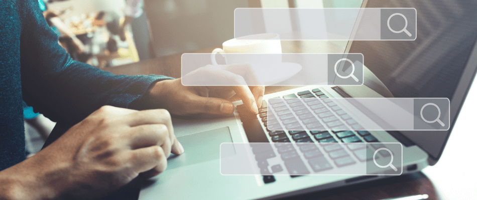 marketer typing seo tips on laptop with search bars floating above