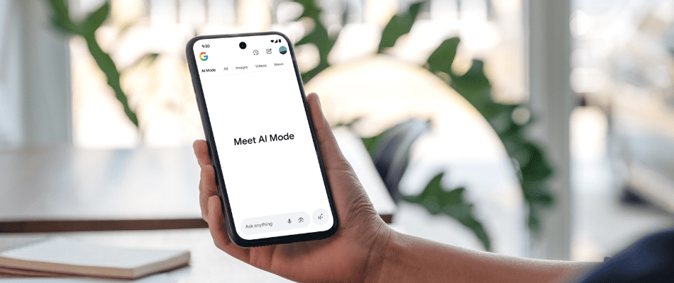image of a woman holding and using Google AI Mode on a mobile phone
