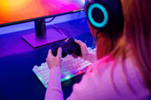 woman wear gaming headphones playing live stream esports games console at home
