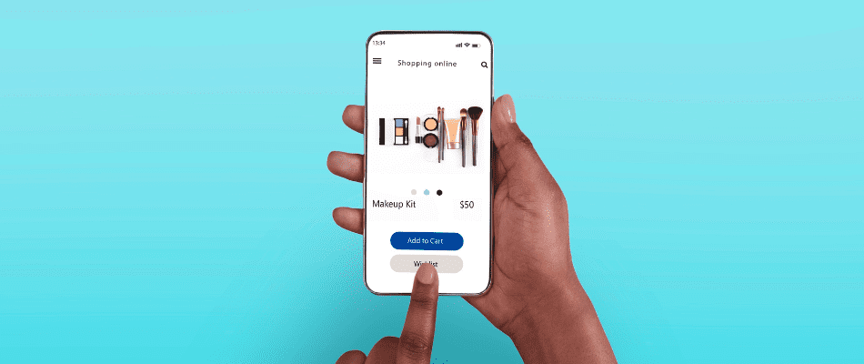 Above top overhead view of black woman browsing online make up store on her smart phone selecting add to wishlist button