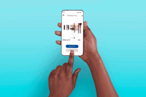 Above top overhead view of black woman browsing online make up store on her smart phone selecting add to wishlist button