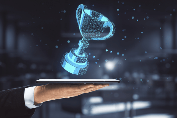 Image of a hand holding a tablet and an AI-rendered trophy extends from the tablet